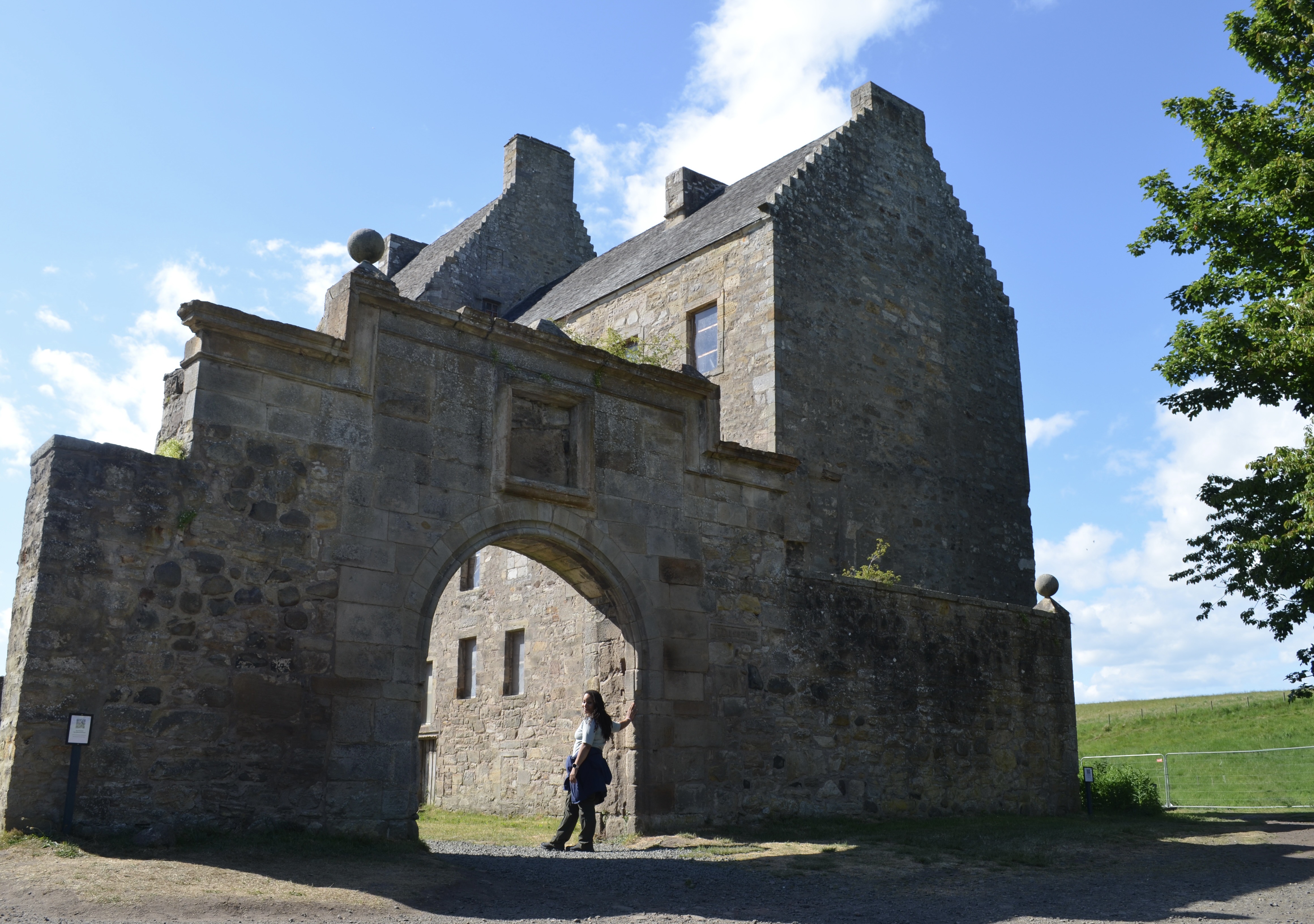 Gene standing in the archway of a Scottish castle